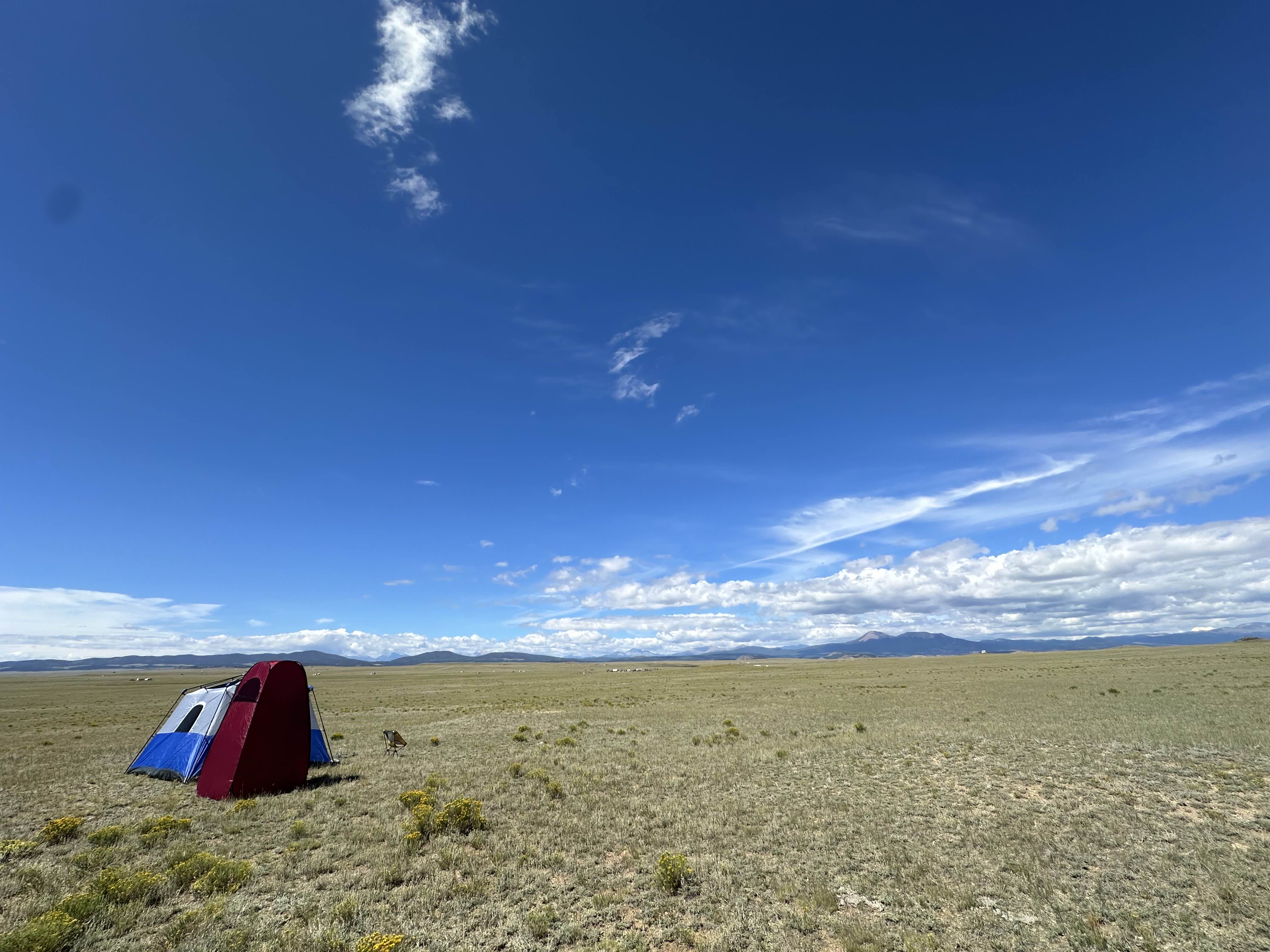 Tent set up on the open plains with 360-degree mountain views